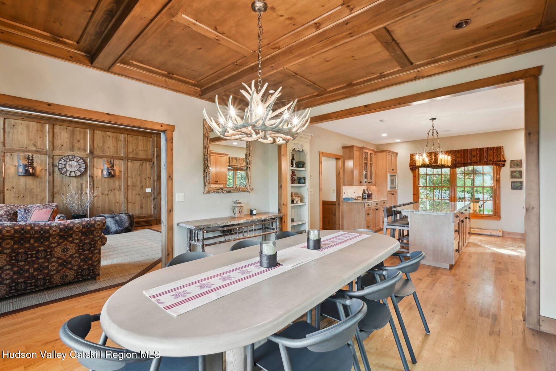 19 Twin Maples Lane Windham, NY 12496 - Photo 21 of 109 a dining room with furniture a chandelier and wooden floor