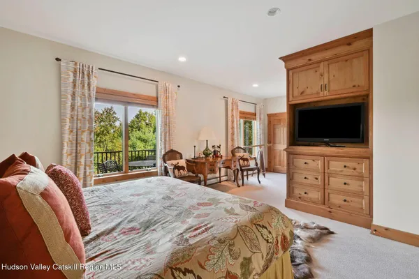 a bedroom with furniture and a window