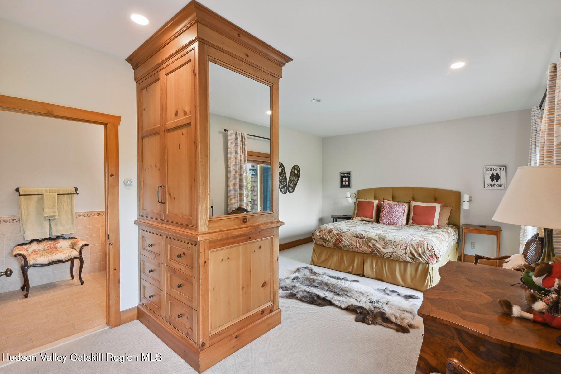 19 Twin Maples Lane Windham, NY 12496 - Photo 30 of 109 a bedroom with furniture and a mirror