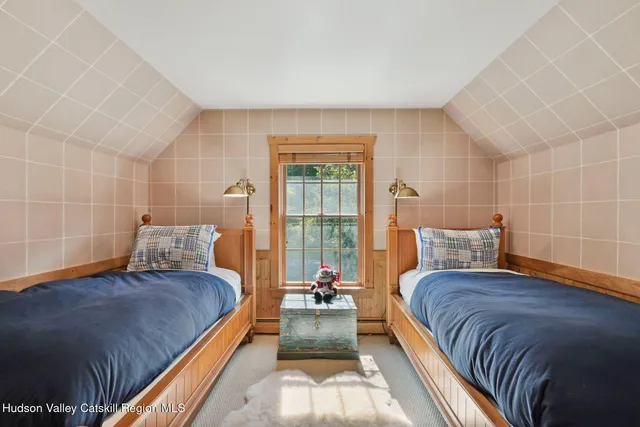 a very nice looking room with a large window and furniture