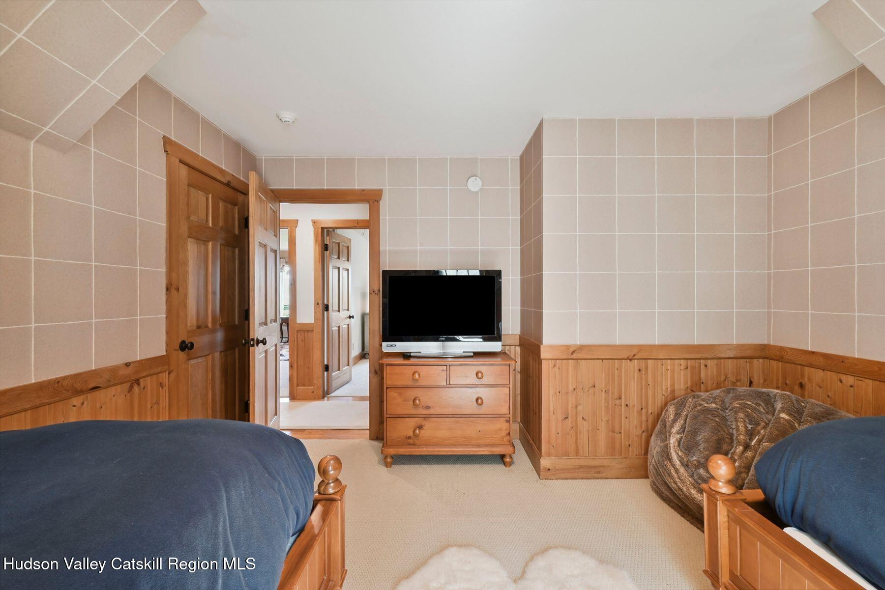 19 Twin Maples Lane Windham, NY 12496 - Photo 40 of 109 a bedroom with a bed and flat screen tv