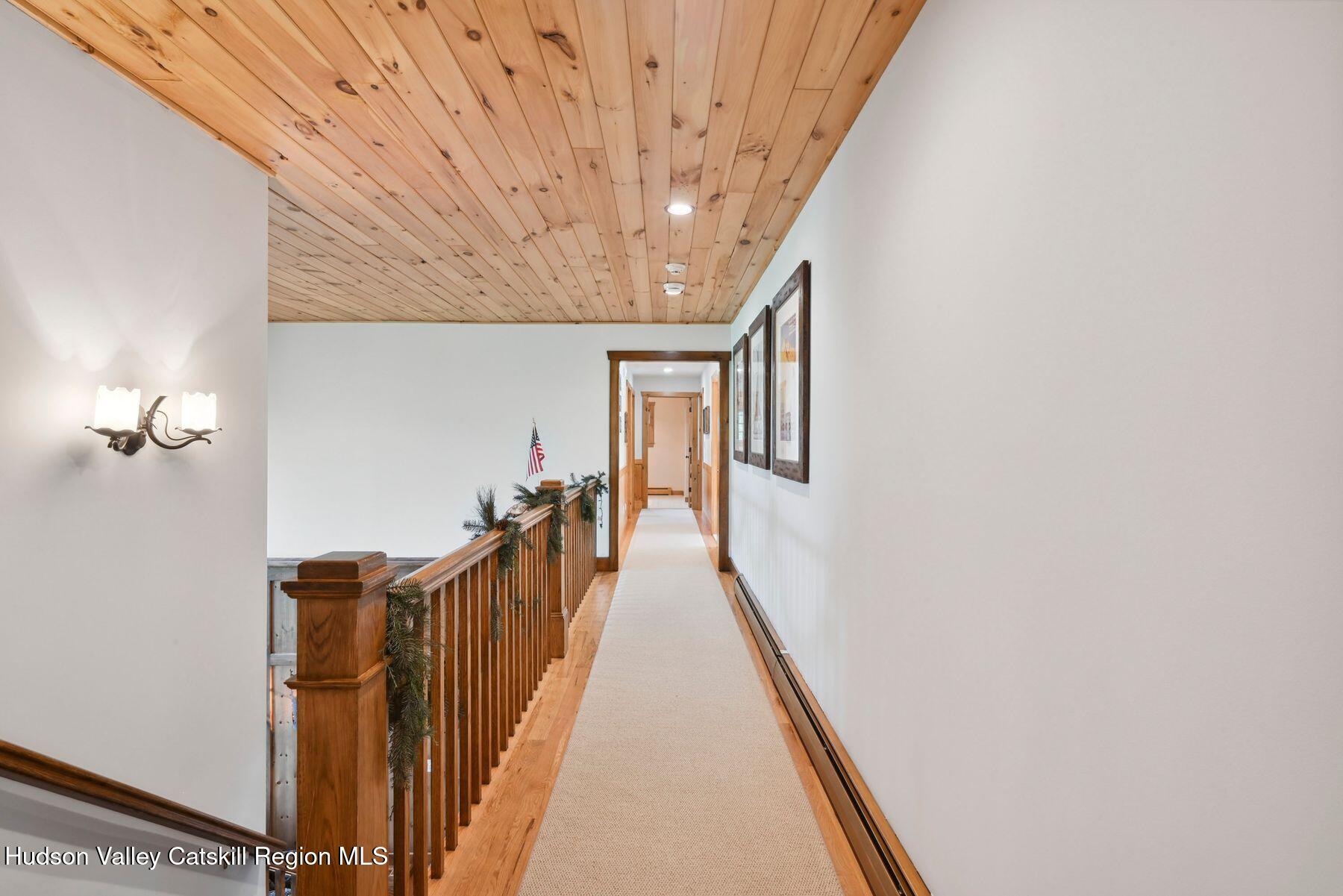 19 Twin Maples Lane Windham, NY 12496 - Photo 50 of 109 a view of a hallway with wooden floor and staircase
