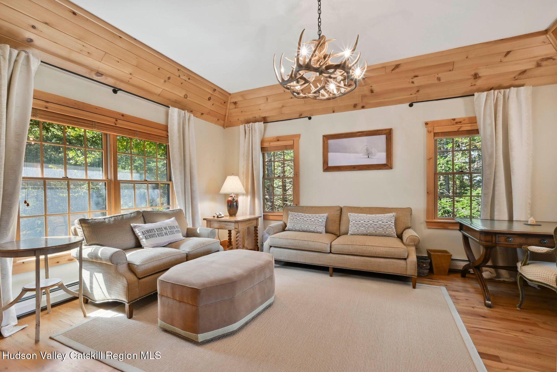 19 Twin Maples Lane Windham, NY 12496 - Photo 52 of 109 a living room with furniture and a chandelier