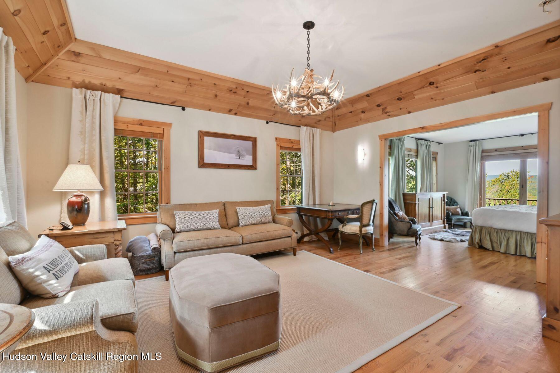 19 Twin Maples Lane Windham, NY 12496 - Photo 54 of 109 a living room with furniture chandelier and a chandelier