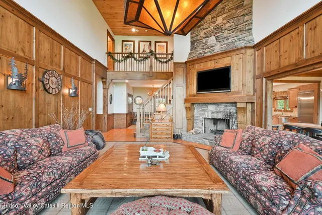 a dining room with furniture a chandelier and wooden floor