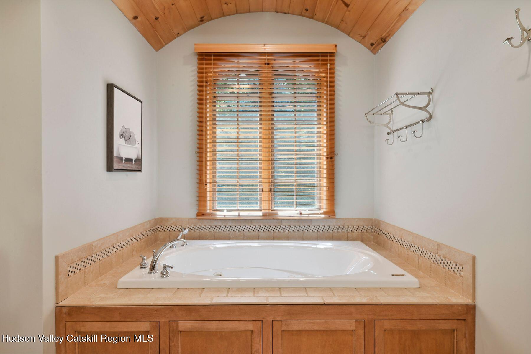 19 Twin Maples Lane Windham, NY 12496 - Photo 88 of 109 a bathroom with a granite countertop sink and a bathtub