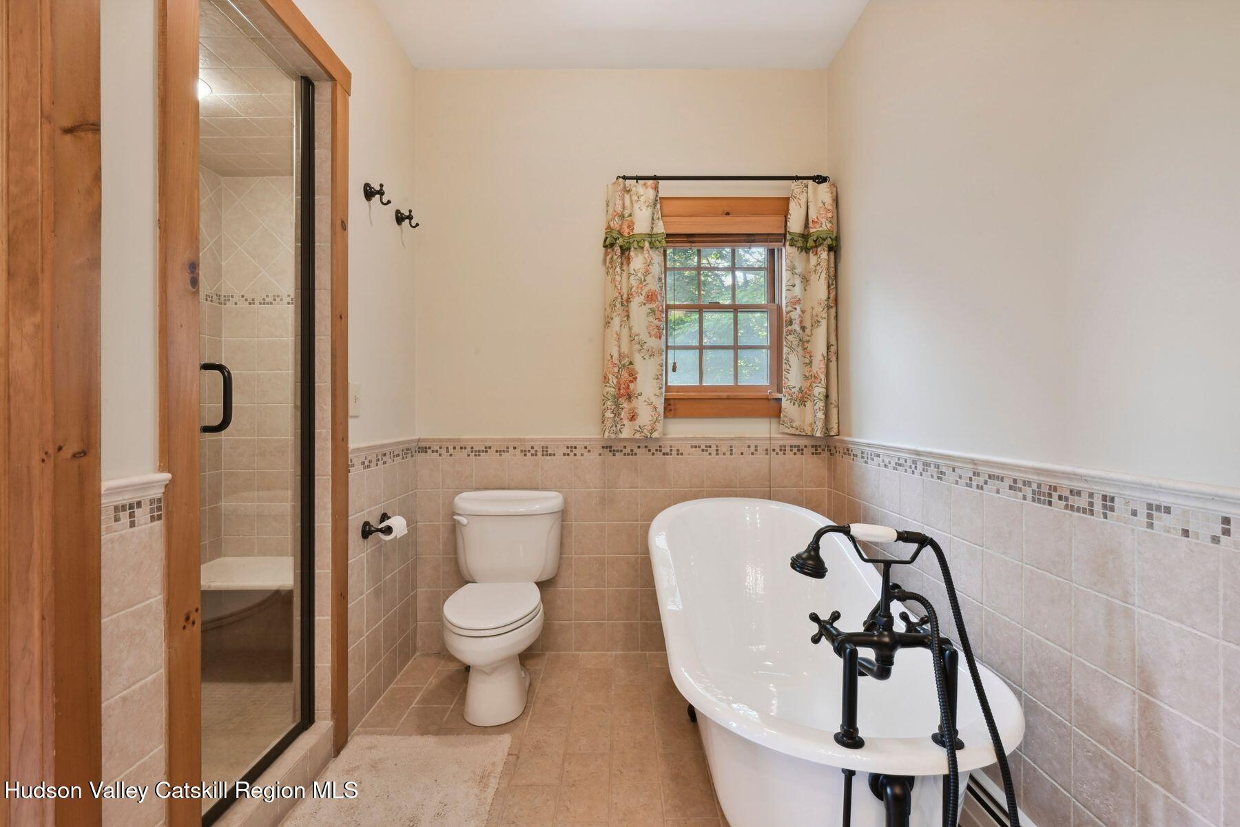 19 Twin Maples Lane Windham, NY 12496 - Photo 97 of 109 a bathroom with a toilet a sink and shower