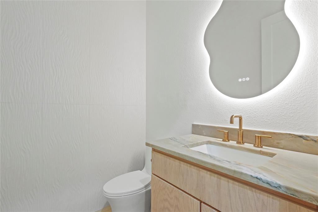 1823 Pollard Street Dallas, TX 75208 - Photo 12 of 28 Bathroom featuring vanity and a textured wall