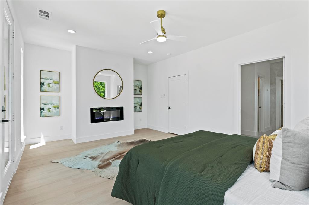 1823 Pollard Street Dallas, TX 75208 - Photo 16 of 28 Bedroom featuring light wood finished floors, a glass covered fireplace, recessed lighting, and a ceiling fan