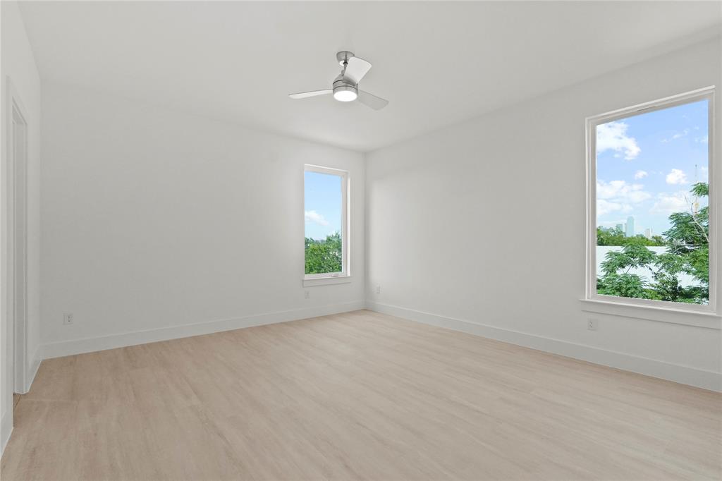 1823 Pollard Street Dallas, TX 75208 - Photo 22 of 28 Unfurnished room with light wood-style flooring and ceiling fan