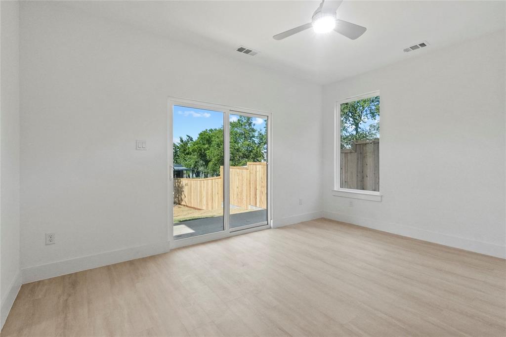 1823 Pollard Street Dallas, TX 75208 - Photo 4 of 28 Empty room with wood finished floors and a ceiling fan