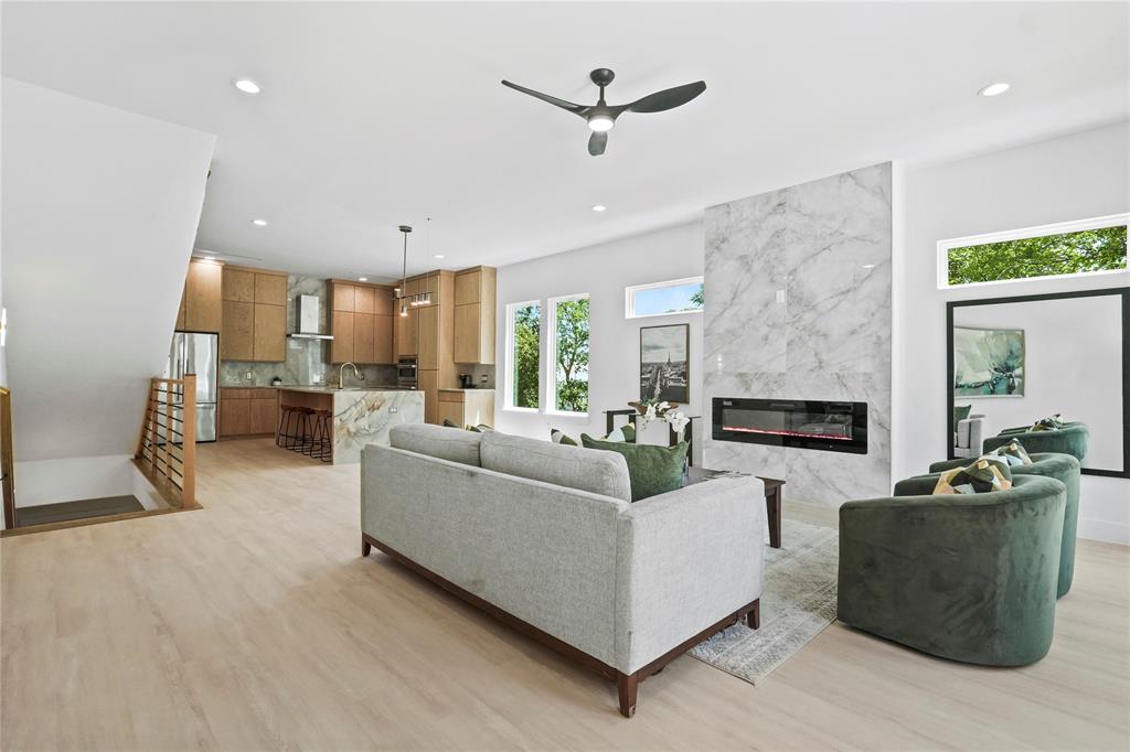 1823 Pollard Street Dallas, TX 75208 - Photo 10 of 28 Living room featuring a ceiling fan, a high end fireplace, recessed lighting, and light wood-type flooring