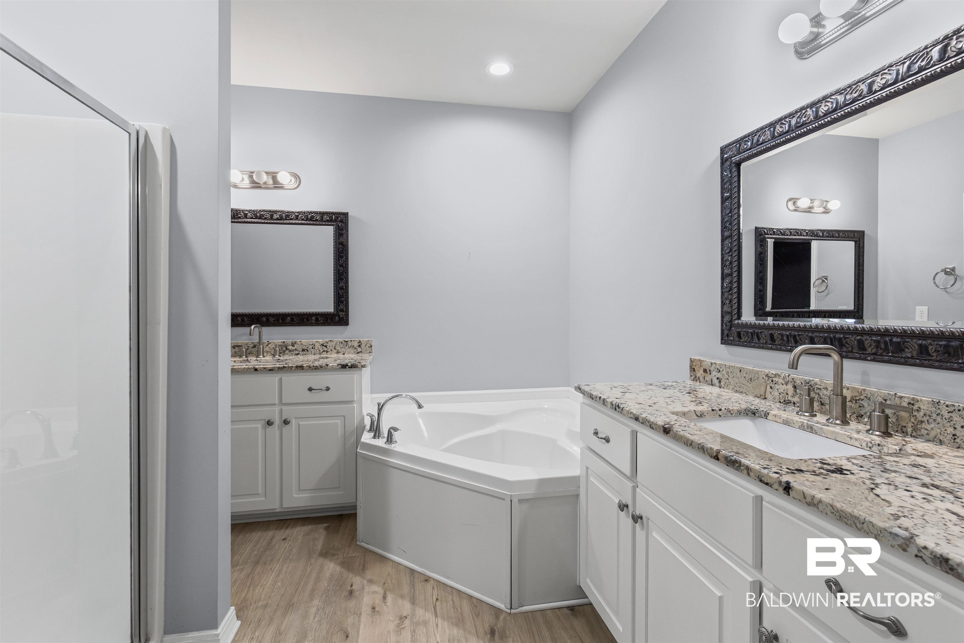 30851 Joseph Drive Spanish Fort, AL 36527 - Photo 13 of 22 Full bathroom with light wood finished floors, a garden tub, two vanities, recessed lighting, and a stall shower