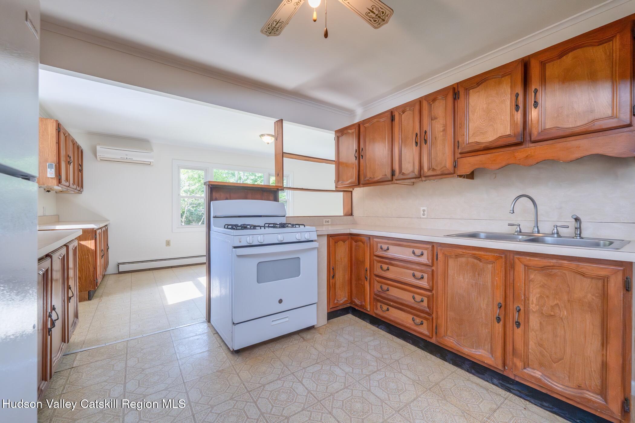 4533 Atwood Road Stone Ridge, NY 12484 - Photo 14 of 63 a kitchen with stainless steel appliances granite countertop a stove a sink and a refrigerator