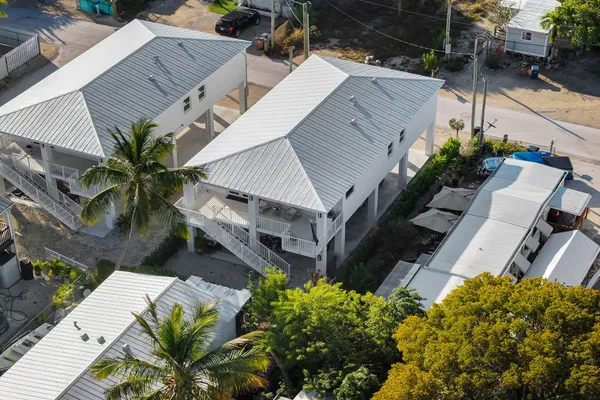 an aerial view of a house with a yard and potted plants