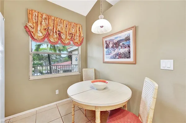 a view of a dining room with furniture a chandelier and wooden floor