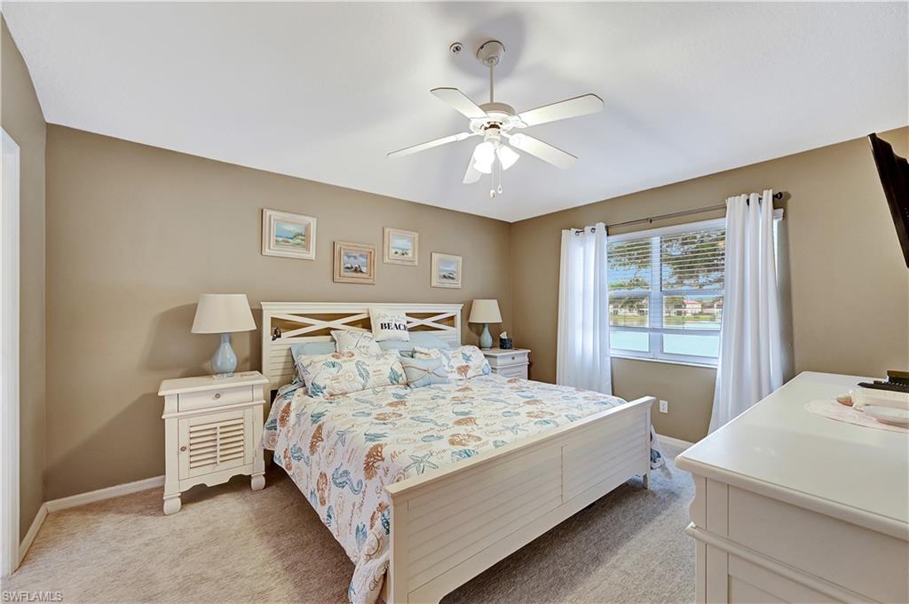 6496 Huntington Lakes Circle, Unit 201 Naples, FL 34119 - Photo 16 of 24 a bedroom with a bed and window