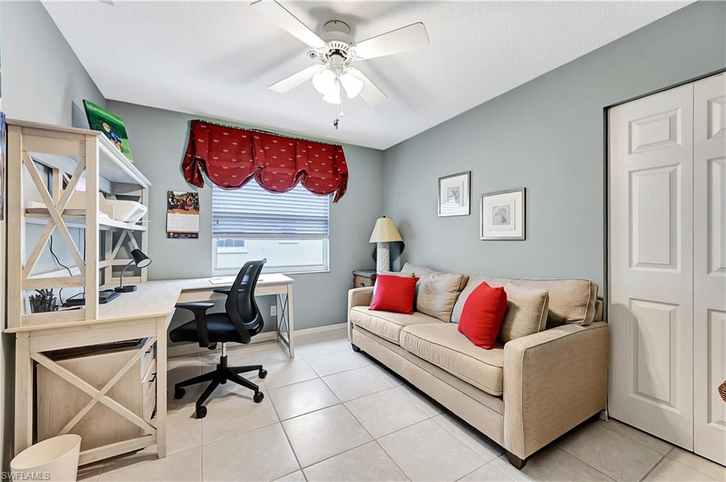 6496 Huntington Lakes Circle, Unit 201 Naples, FL 34119 - Photo 21 of 24 a living room with furniture and a couch