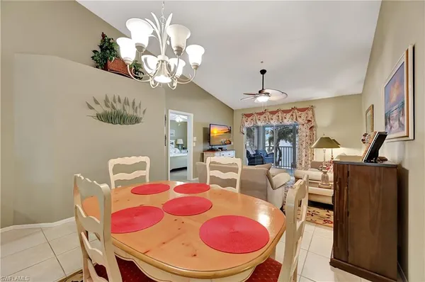 a view of a dining room with furniture wooden floor and chandelier