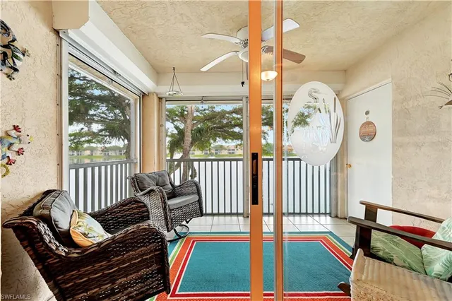a living room with furniture and a floor to ceiling window