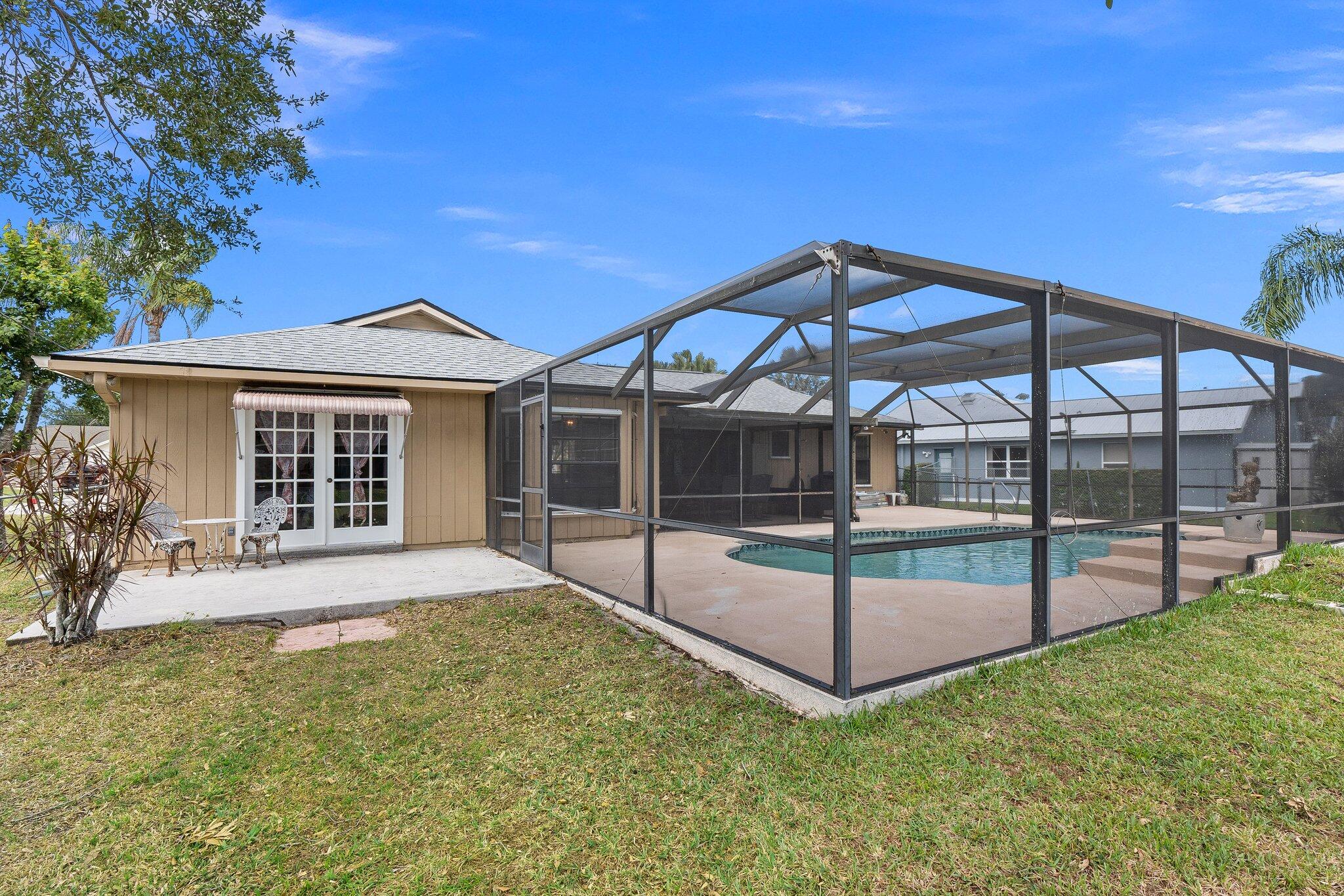 547 Southeast Cliff Road Port St. Lucie, FL 34984 - Photo 6 of 33 Backyard w/Primary Bedroom Entrance