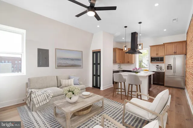 a living room with furniture kitchen and a window