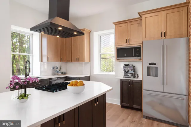 a kitchen with stainless steel appliances a sink stove and refrigerator