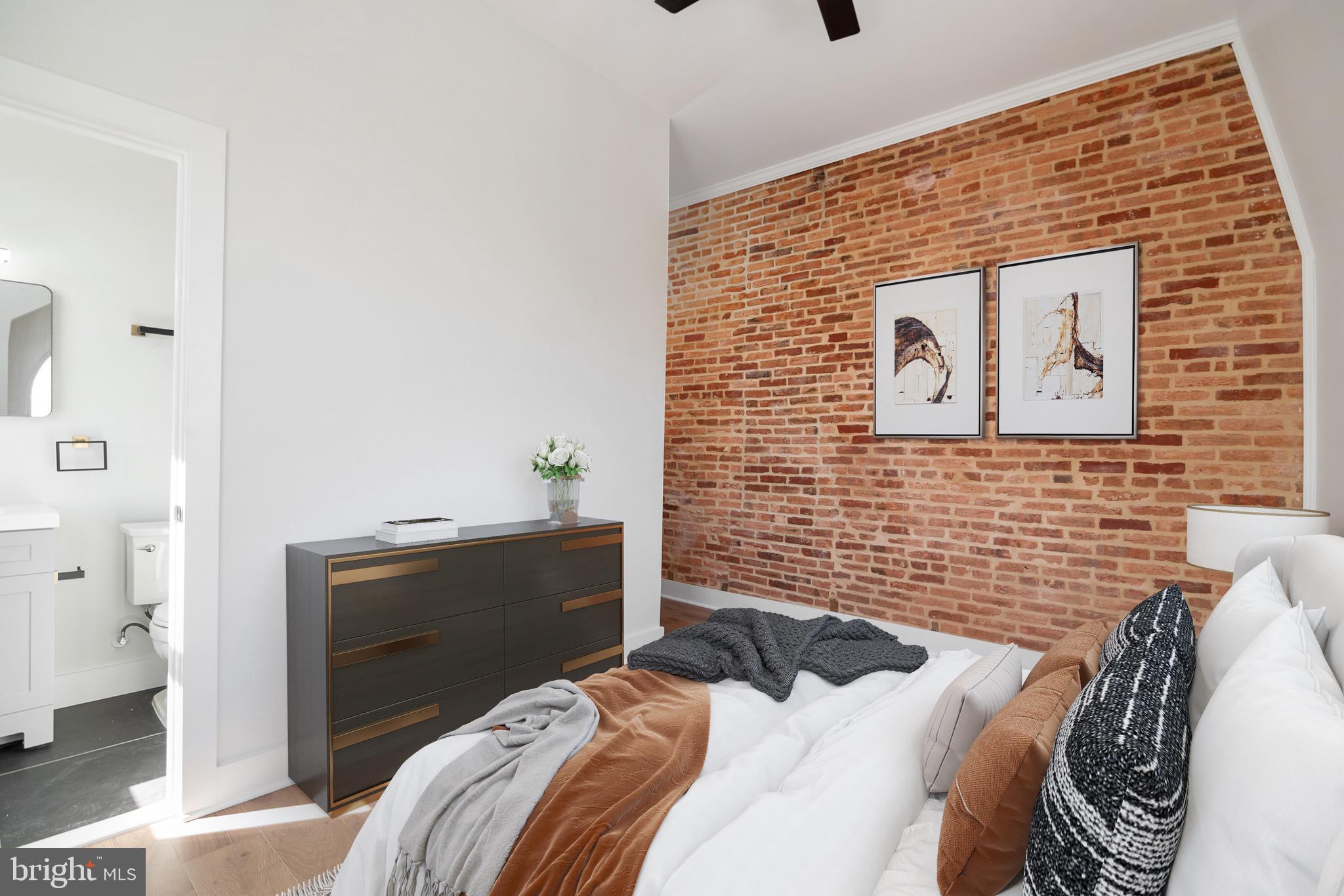 118 East 24th Street, Unit 3 Baltimore, MD 21218 - Photo 7 of 17 a bedroom with a bed and a desk