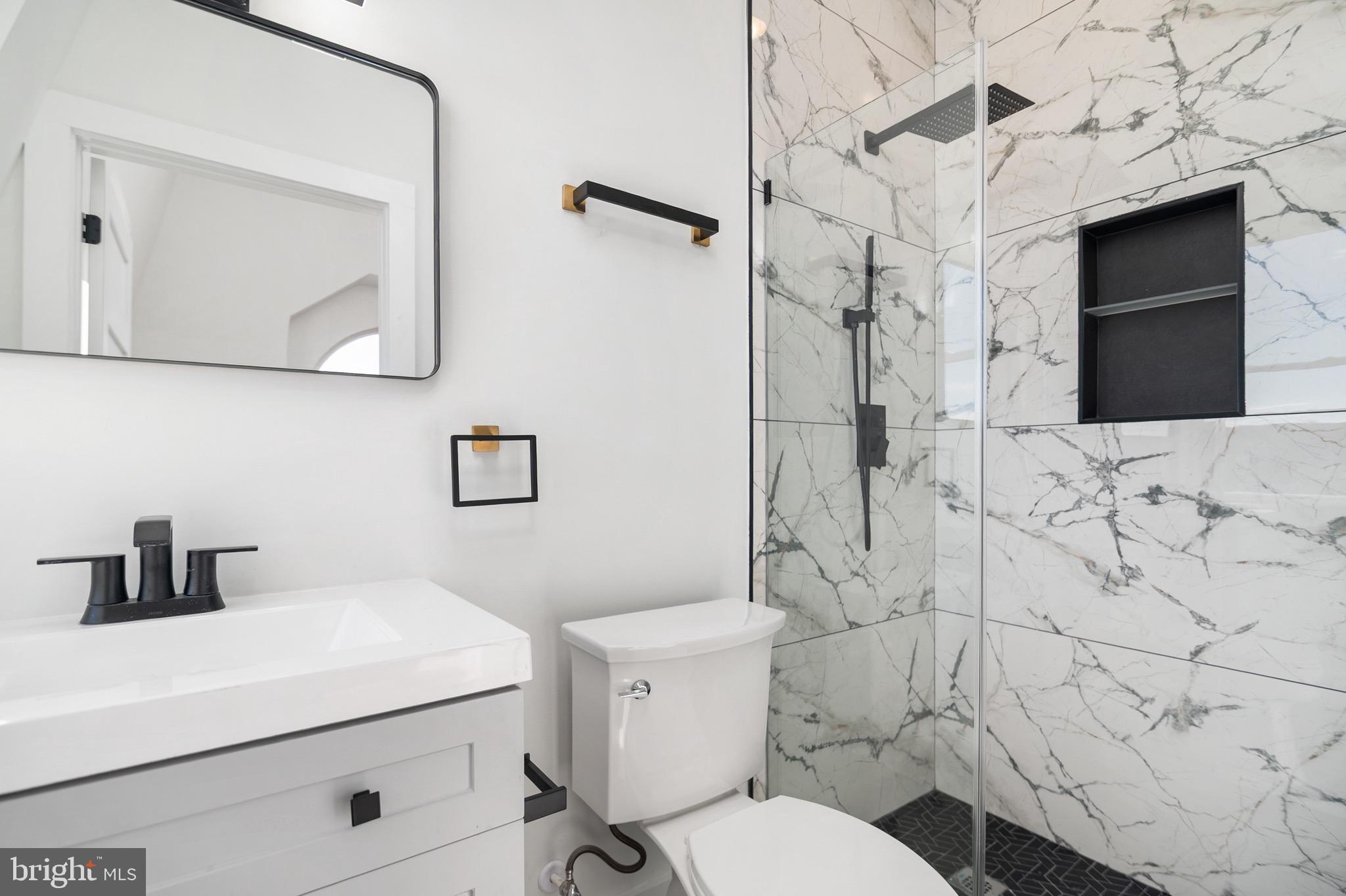 118 East 24th Street, Unit 3 Baltimore, MD 21218 - Photo 8 of 17 a bathroom with a sink toilet and shower