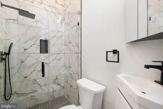 a bathroom with a sink toilet and shower