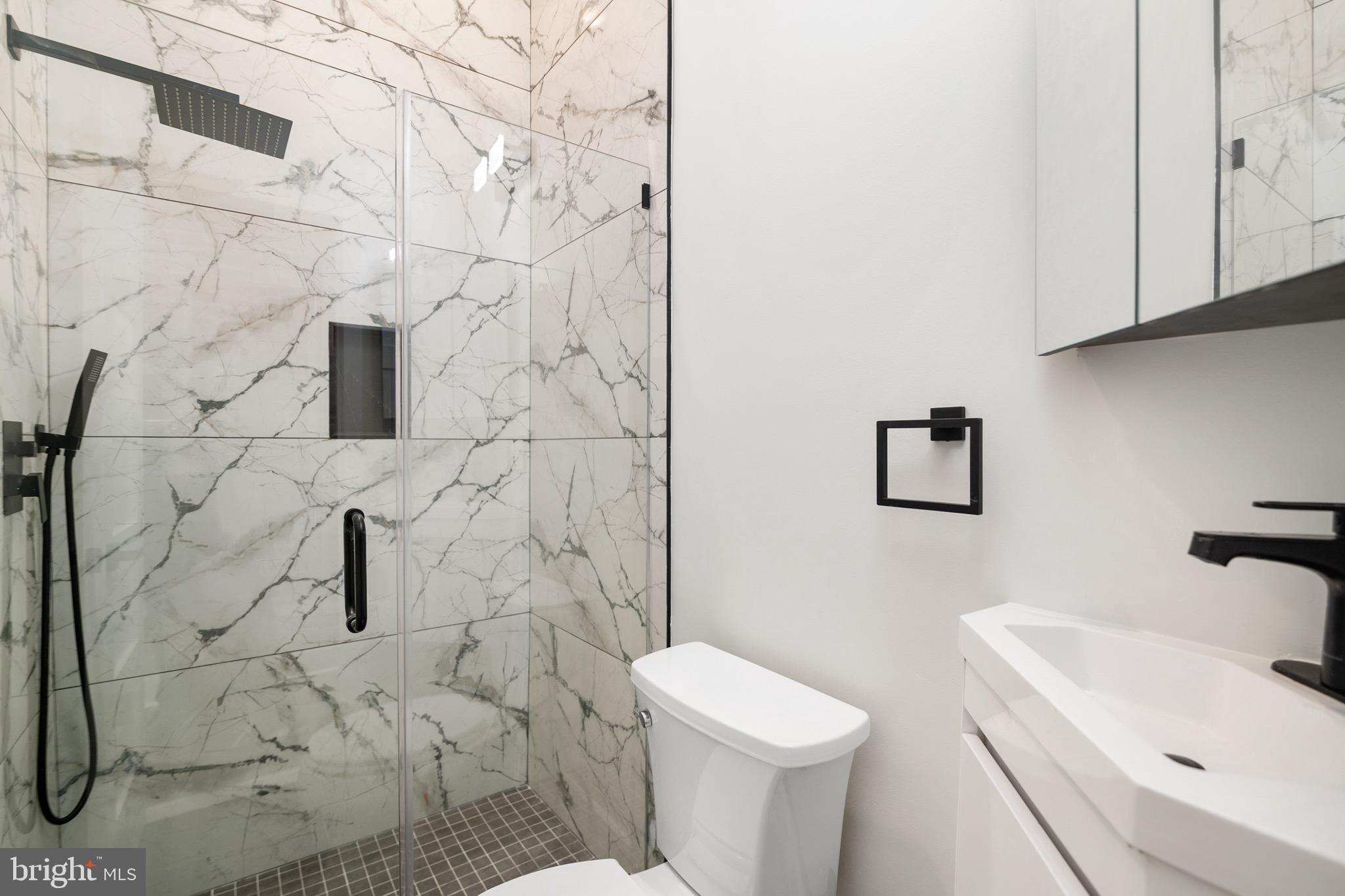 118 East 24th Street, Unit 3 Baltimore, MD 21218 - Photo 10 of 17 a bathroom with a sink toilet and shower