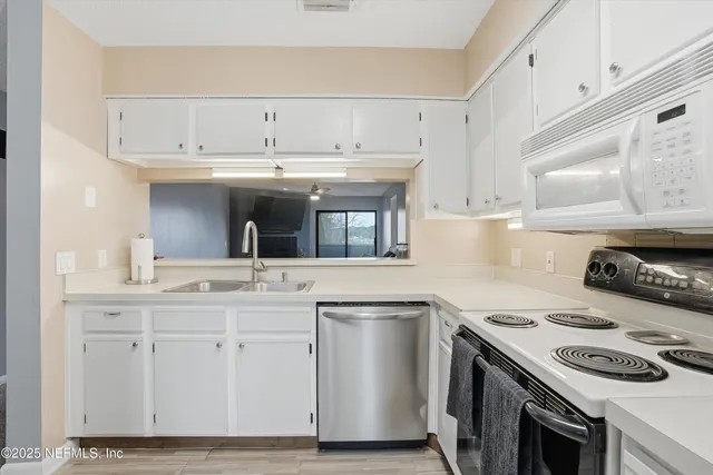 a kitchen with a sink and cabinets