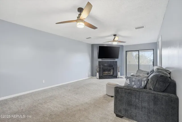 a living room with furniture and a fireplace