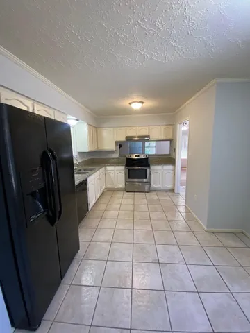 a view of a livingroom with an empty space and a window