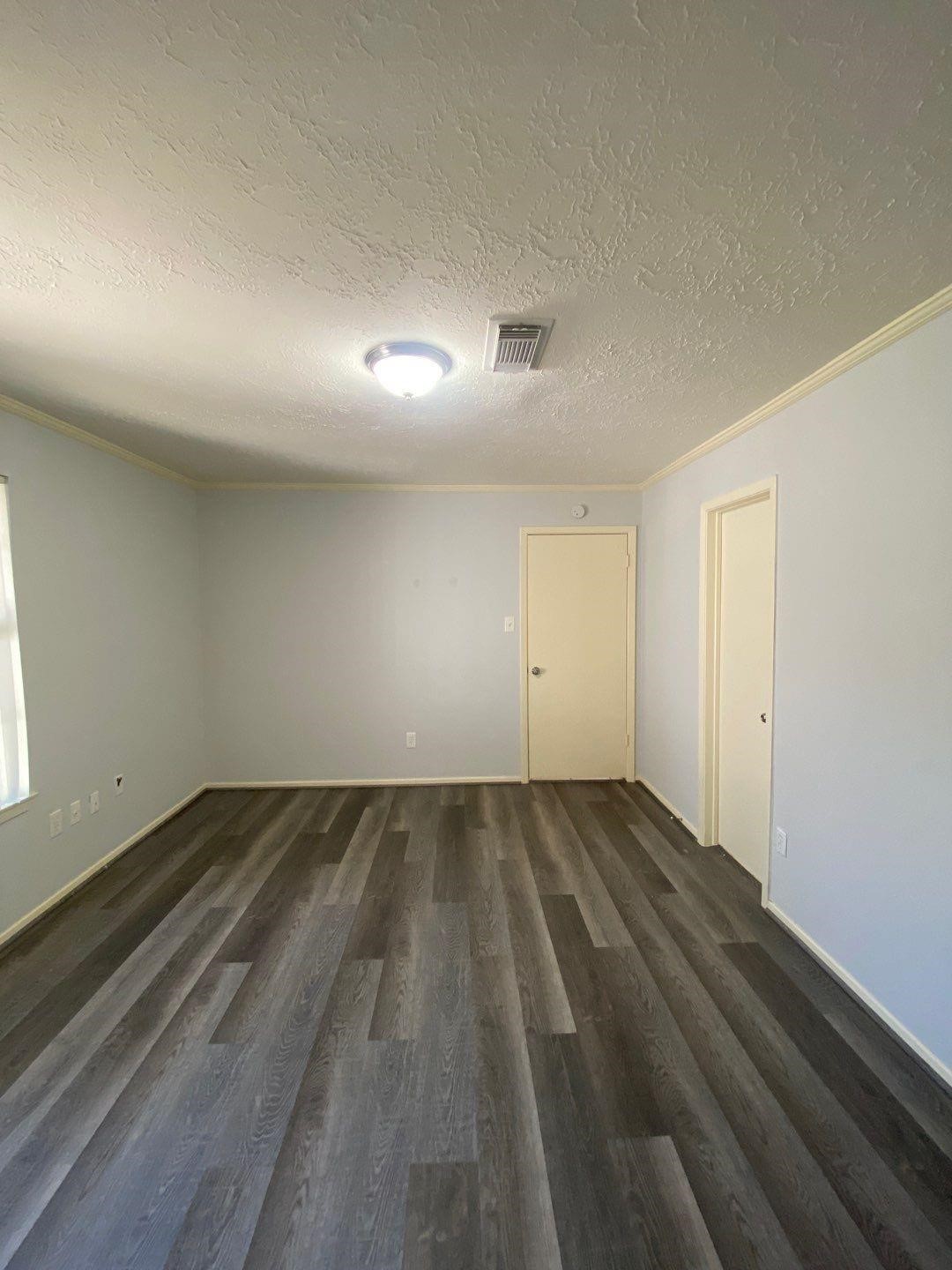 6406 Brookgate Drive Spring, TX 77373 - Photo 15 of 28 an empty room with wooden floor and windows