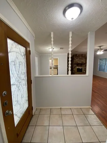 a view of a livingroom with a ceiling fan window and wooden floor