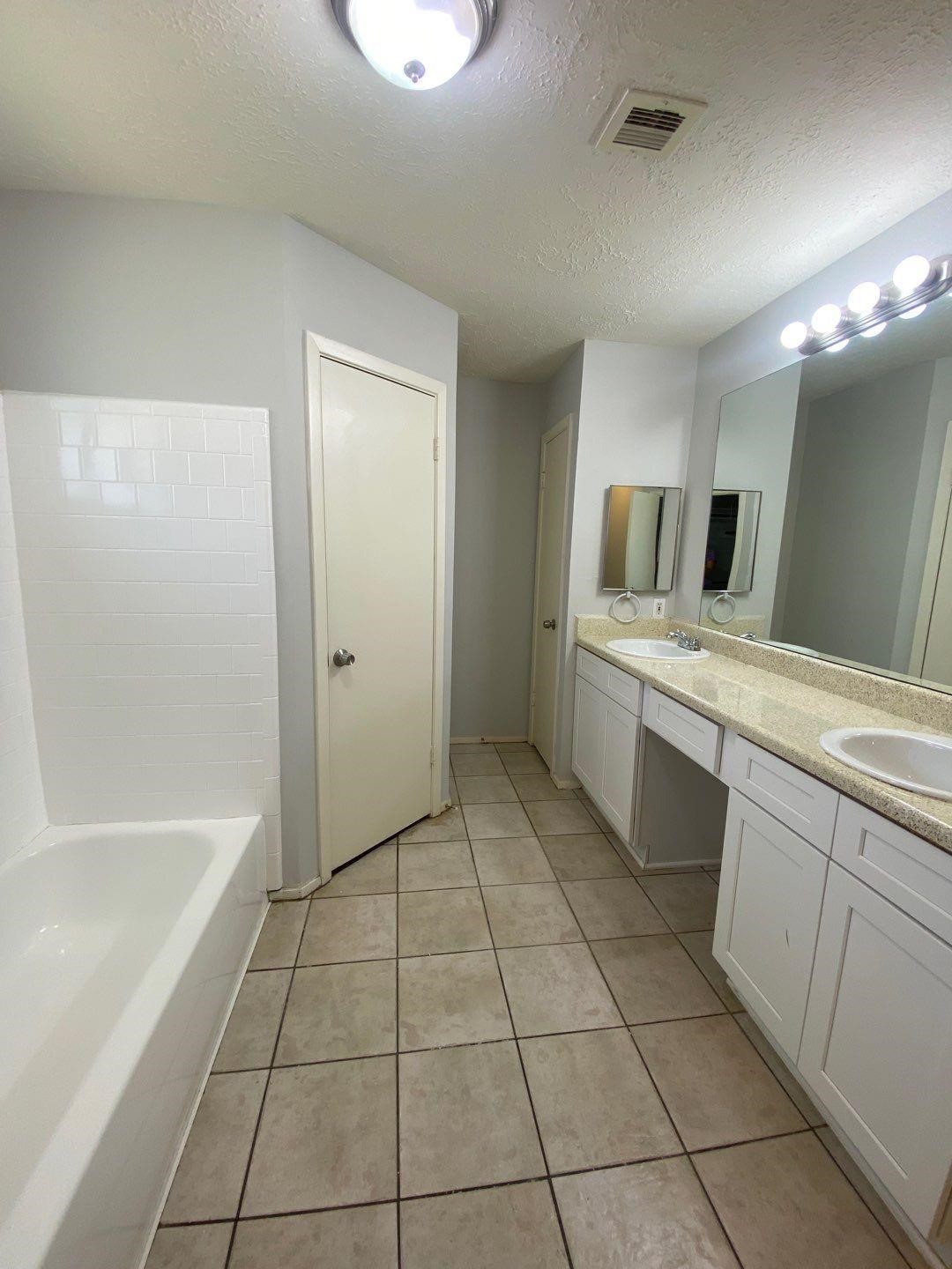 6406 Brookgate Drive Spring, TX 77373 - Photo 22 of 28 a bathroom with a sink a mirror and a bathtub