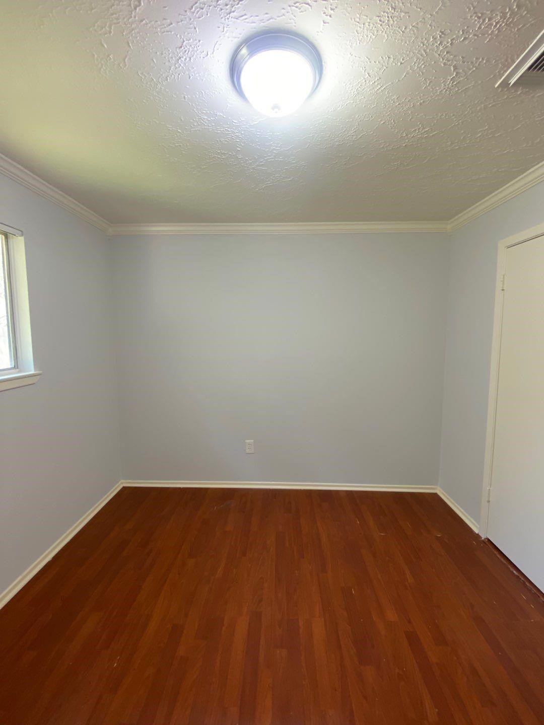 6406 Brookgate Drive Spring, TX 77373 - Photo 9 of 28 an empty room with wooden floor and windows