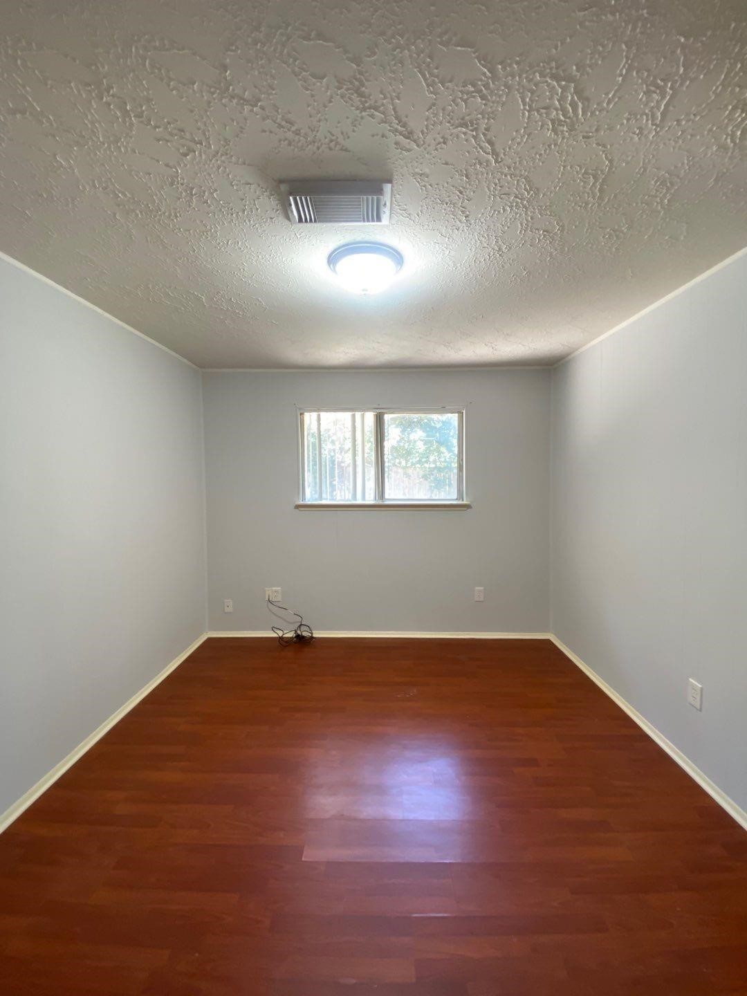 6406 Brookgate Drive Spring, TX 77373 - Photo 10 of 28 an empty room with wooden floor and windows