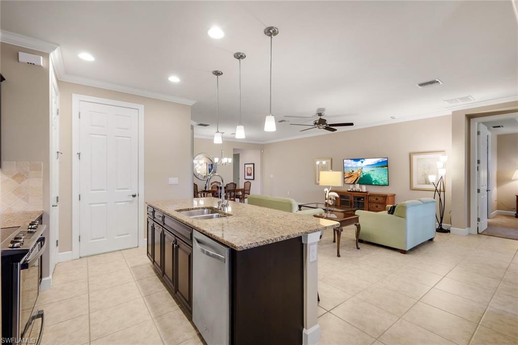 10820 Rutherford Road Fort Myers, FL 33913 - Photo 15 of 42 Kitchen island with a light-toned countertop, integrated double sink, and dishwasher