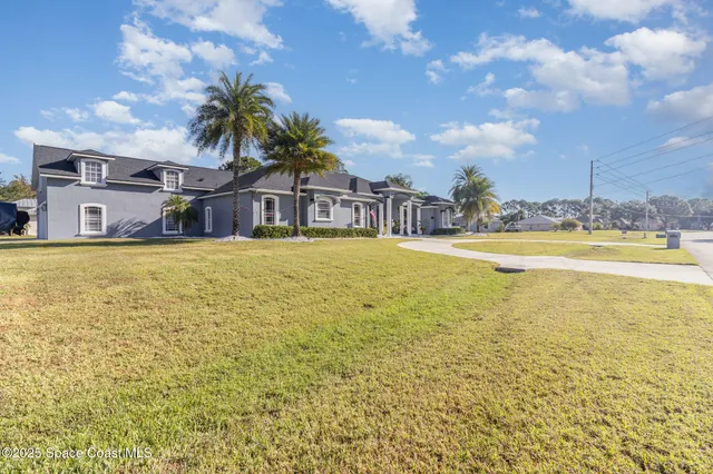 a front view of house with yard and trees