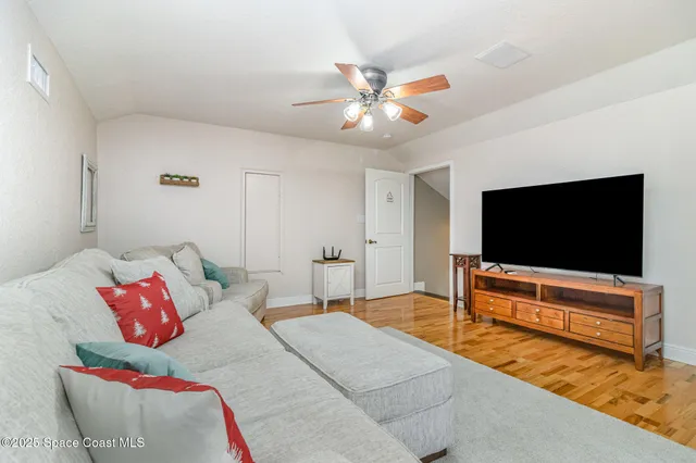 a spacious bedroom with a bed and a dresser