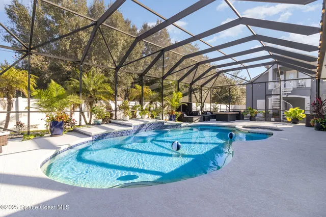 a large room with kitchen island granite countertop a sink and dishwasher wooden cabinets with granite countertops