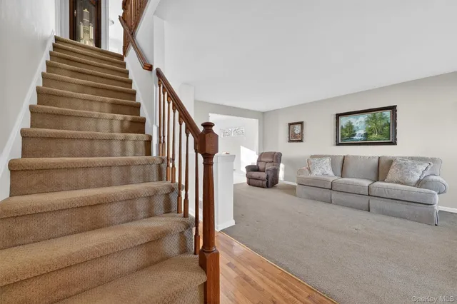a living room with furniture and stairs