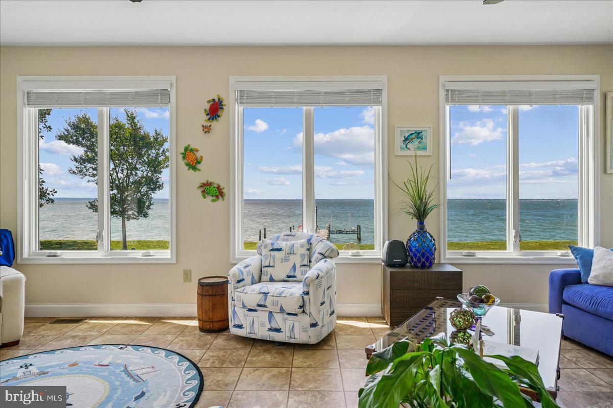 12195 Potomac View Road Newburg, MD 20664 - Photo 37 of 91 a living room with furniture and floor to ceiling windows
