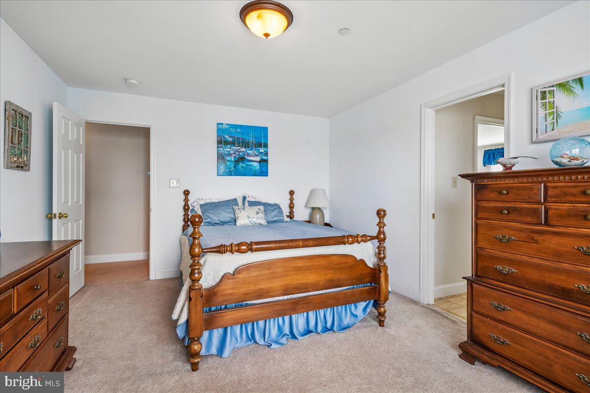 12195 Potomac View Road Newburg, MD 20664 - Photo 48 of 91 a bedroom with a bed and a dresser