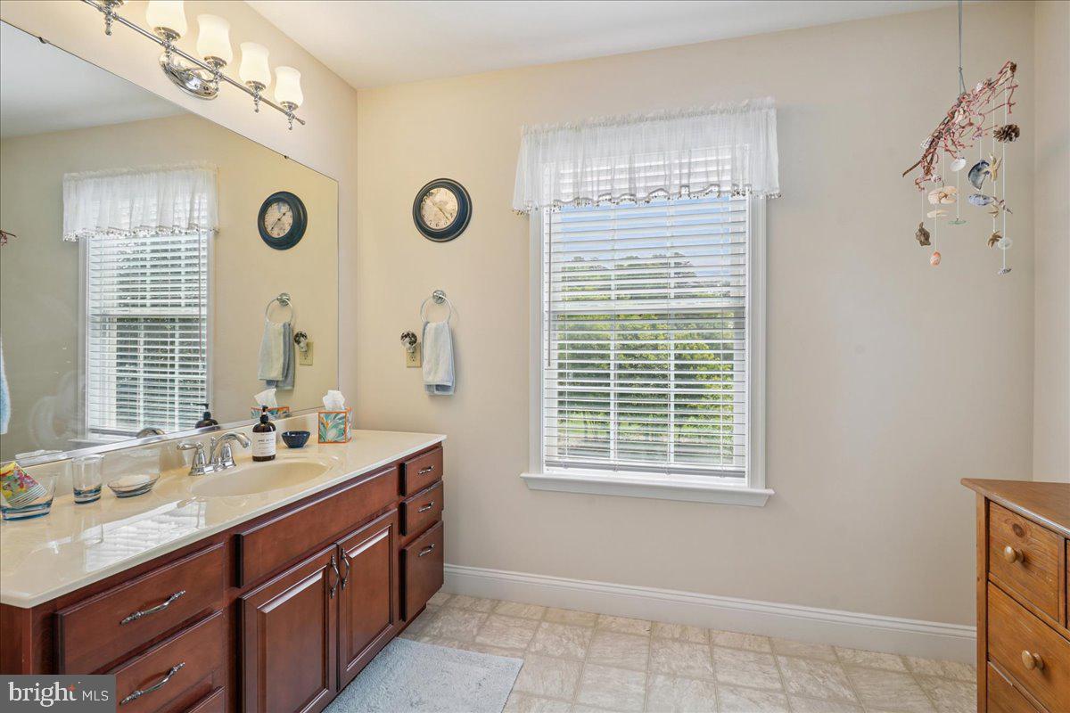 12195 Potomac View Road Newburg, MD 20664 - Photo 51 of 91 a spacious bathroom with double vanity and a mirror