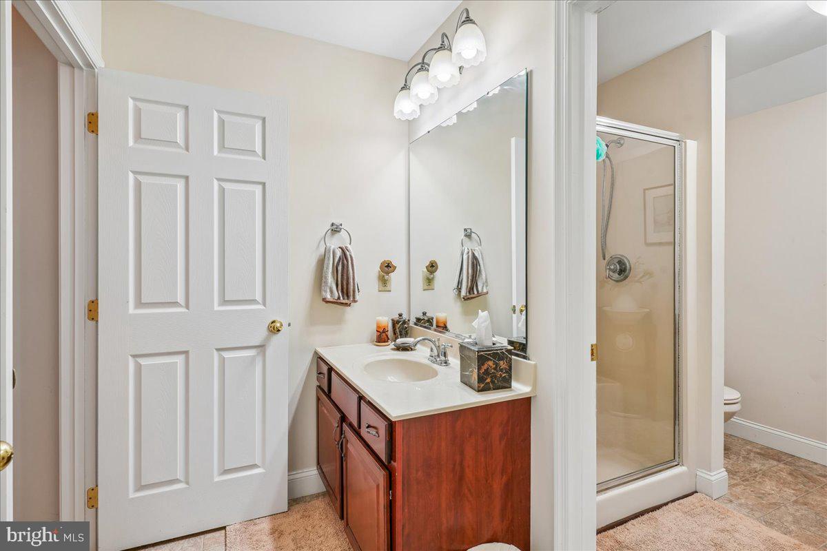 12195 Potomac View Road Newburg, MD 20664 - Photo 62 of 91 a bathroom with a double vanity sink mirror and shower