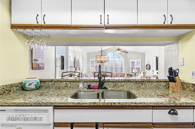 a balcony with furniture and a large window