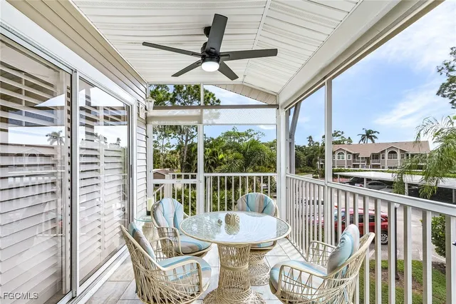 a view of a chair and tables in the balcony
